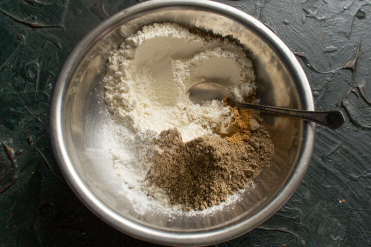 Mixing dry ingredients Wheat flour, flaxseed meal, and spices mixed in a bowl