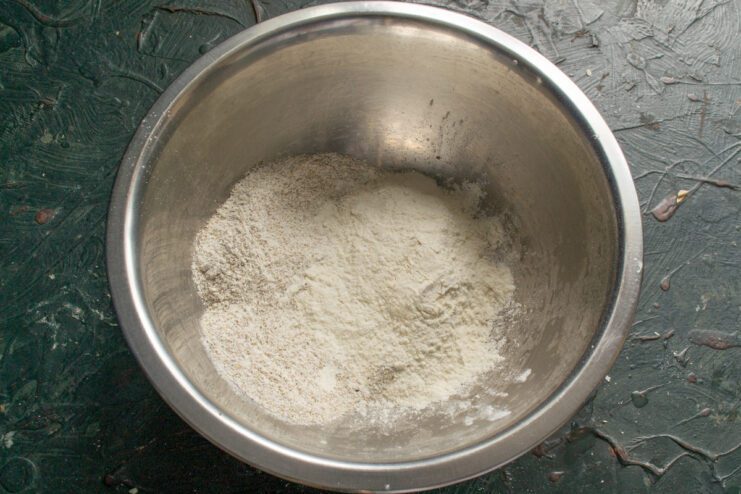 Mixing rye and wheat flours Whisking together whole grain rye and durum wheat flours in a mixing bowl