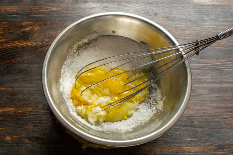 Whisking egg and sugar Whisking an egg and granulated sugar together in a small mixing bowl.