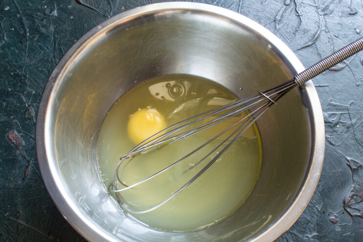 Preparing the liquid ingredients Mixing egg yolk and whey in a glass bowl for the pancake batter