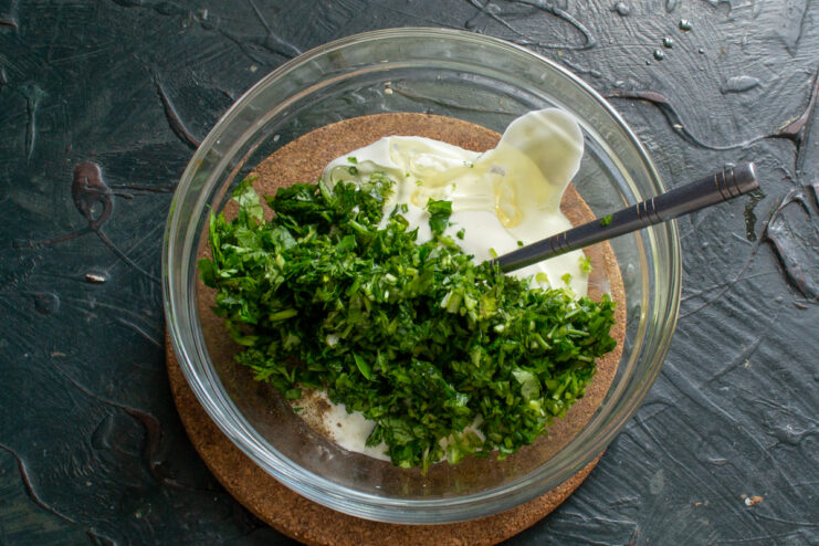 Adding cilantro to the sauce Sour cream mixed with finely chopped fresh cilantro.