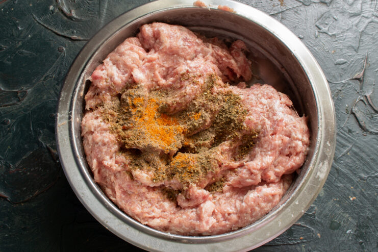Spices for homemade sausages Spices and paprika on top of ground pork