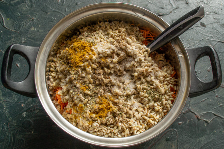 Seasoning the stew Spices and salt sprinkled over ingredients in a pot