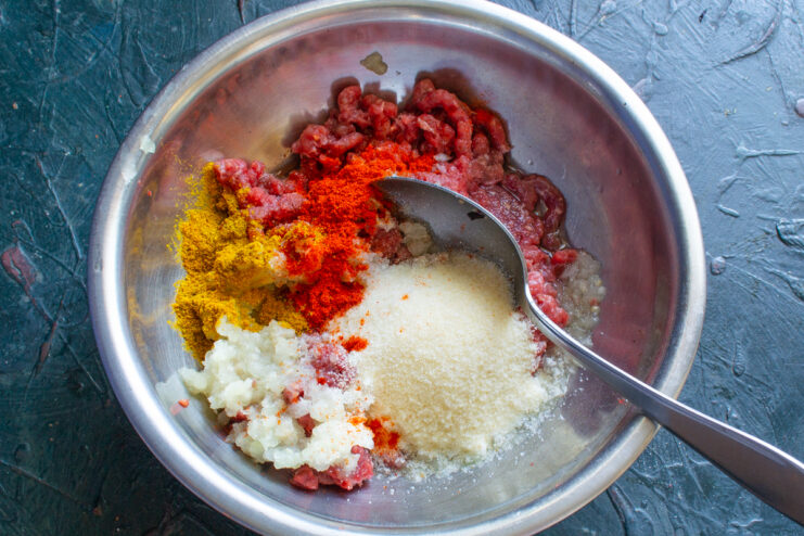 Seasoning The Meat Paprika, curry, and pepper sprinkled over the meat mixture