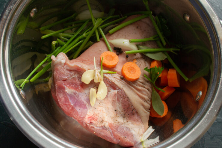 Aromatic Herbs Herb stems in a pot with pork and vegetables.