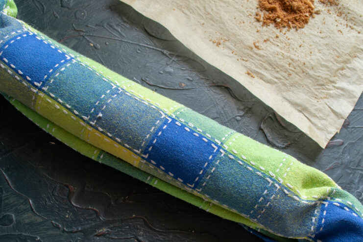 Rolling the cake Hot marble sponge cake rolled up tightly in a kitchen towel