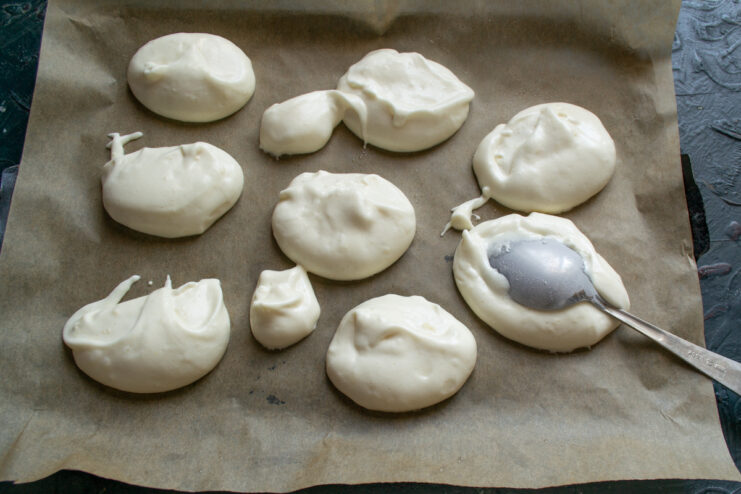 Spoon the light batter Dollops of light vanilla batter arranged on a baking sheet