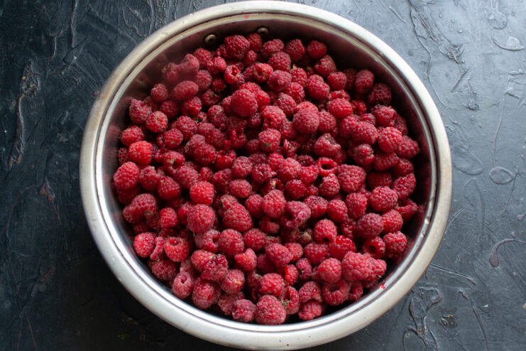 Preparing the raspberries Fresh ripe raspberries in a metal bowl
