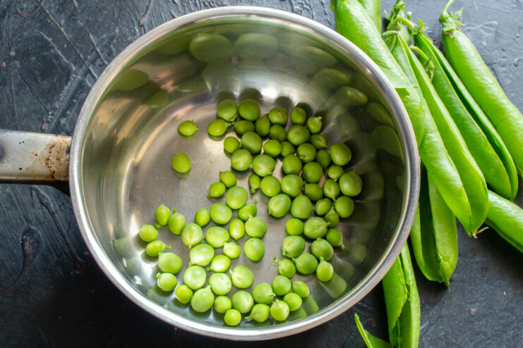 Blanching the peas Fresh green peas blanching in a saucepan