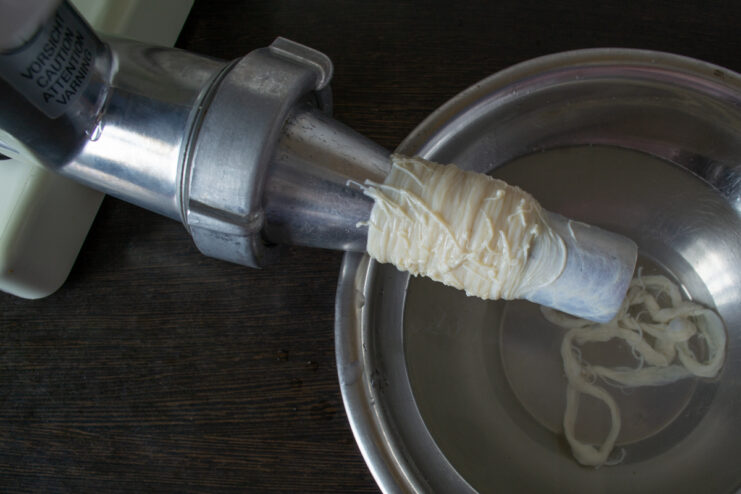Prepping the casing Hog casing on a sausage stuffer attachment