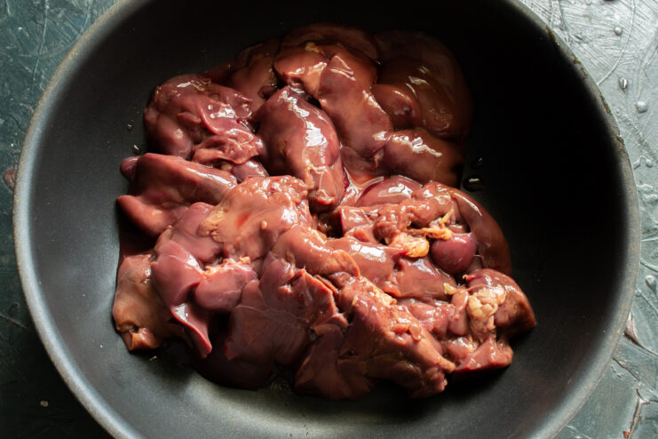 Prepping The Chicken Livers Raw chicken livers in a bowl before cleaning and trimming