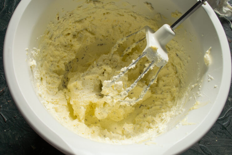 Curd mixture with toasted caraway seeds Mixed cheese mass speckled with toasted caraway seeds in a bowl