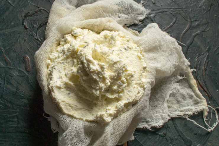 Shaping the cheese wheel Cheese mixture scooped into a cheesecloth-lined bowl for shaping
