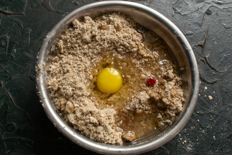 Adding binding ingredients Raw egg and vegetable oil added to the cookie dough mixture
