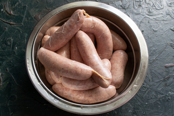 Raw homemade sausages Raw shaped sausages in a metal bowl