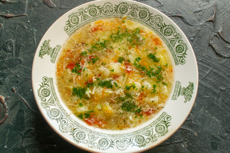 Serving the Fish Soup Top view of a bowl with finished fish soup and fresh herbs