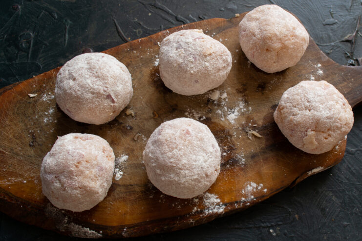 Fish meatballs coated in flour on a plate