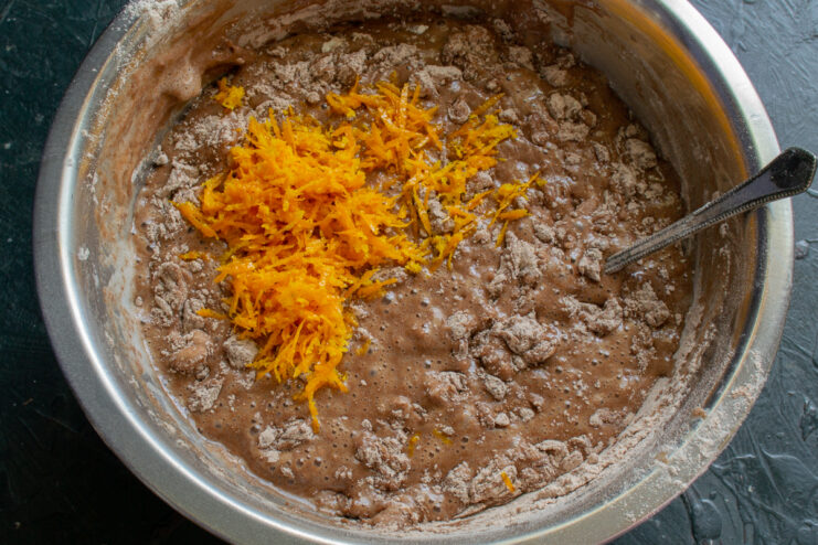 Adding the zest Freshly grated orange zest sitting on top of the chocolate batter