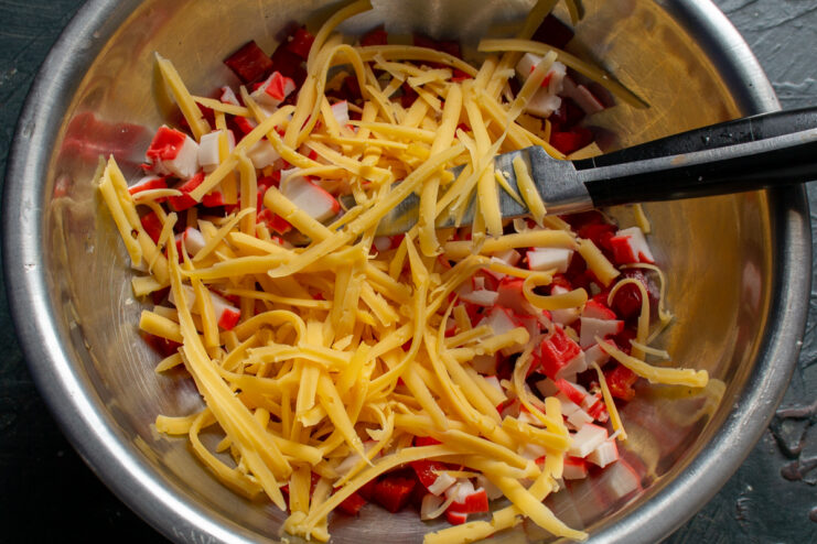 Grating The Cheese Grated cheese added to the salad ingredients