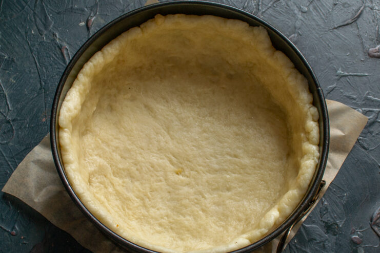 Rolled dough pressed into the bottom and sides of a springform pan