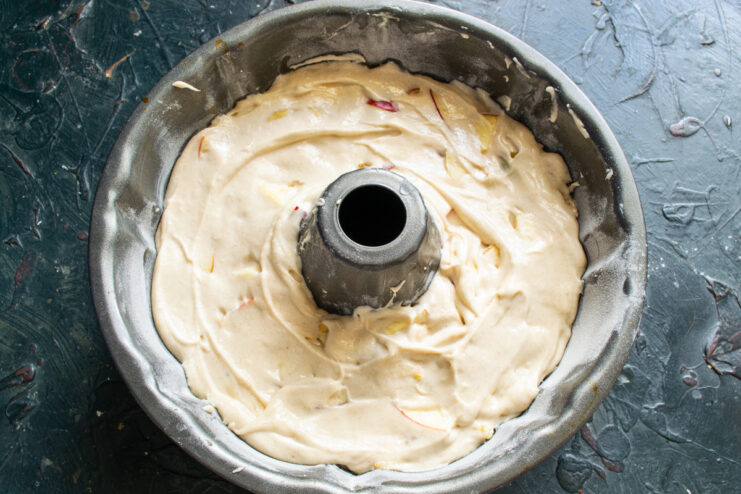 Batter in the baking pan Apple cake batter spread evenly in a tube pan