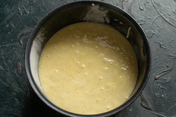 Prepping For Baking Cake batter poured into a round baking pan