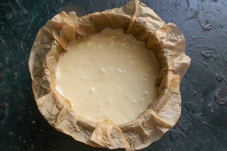 Batter ready for baking Cake batter poured and leveled in a lined springform pan