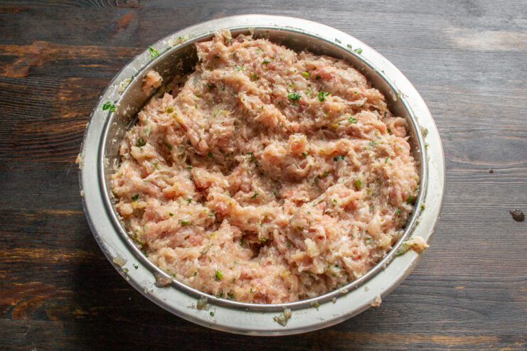Kneading The Meat Mixture Thoroughly kneaded, smooth ground meat mixture resting in a bowl.