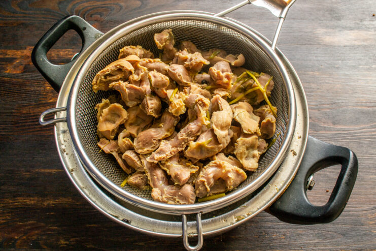 Draining the gizzards Boiled chicken gizzards resting in a colander
