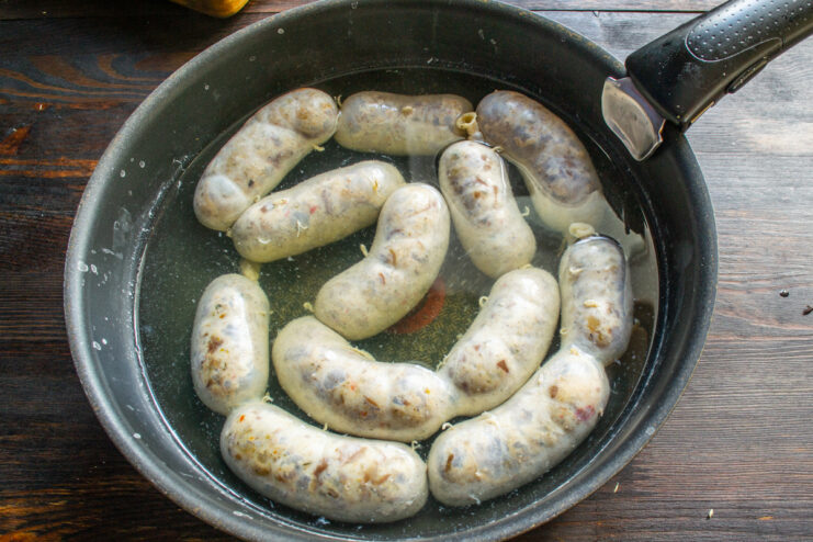 Poaching the sausages Poaching sausages in a pan of hot water