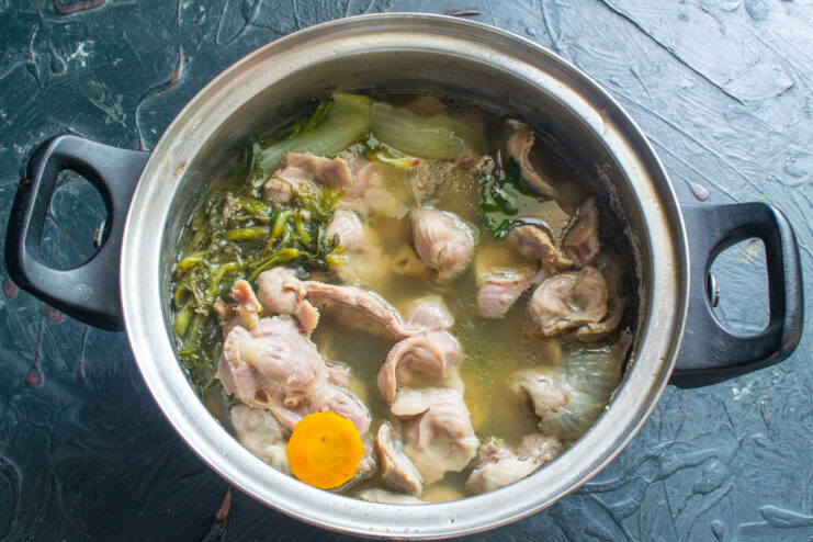 The slow simmering process Simmering chicken gizzards in a pot on the stove