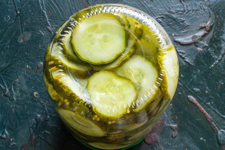 Canned Pickles Ready for Storage Top view of a sealed jar filled with homemade sliced pickles