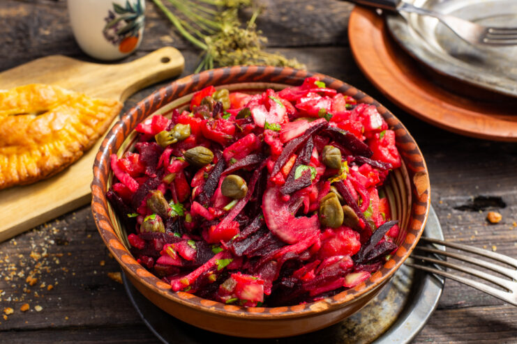 Roasted vegetable Vinegret with capers in a ceramic bowl