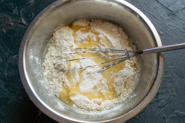 Pouring melted butter into the crepe batter