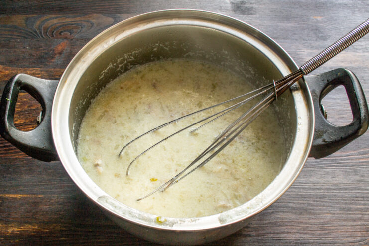 Pouring the egg-lemon sauce into the pot while whisking continuously