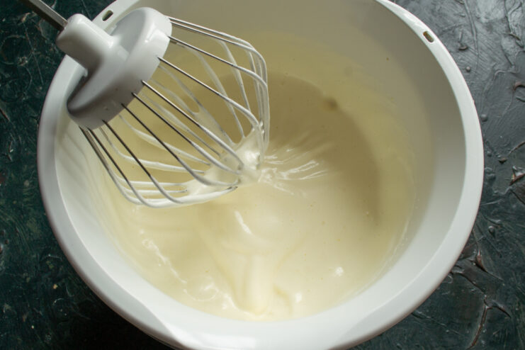 Fluffy egg mixture Thick and fluffy whipped egg and sugar mixture in a bowl