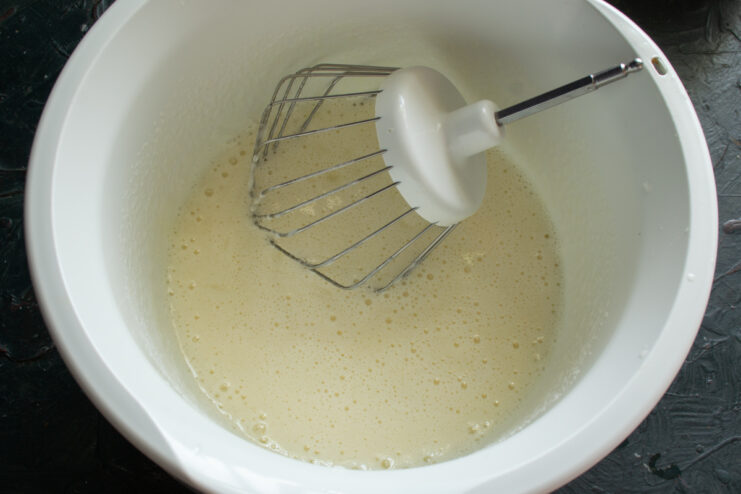 Whisking eggs with sugar Whipped egg and sugar mixture in a mixer