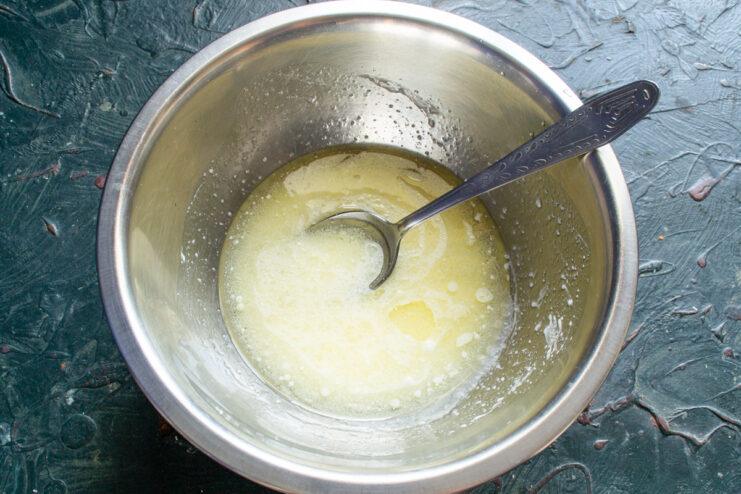 Whisking the wet dough mixture Whisking wet ingredients in a metal bowl