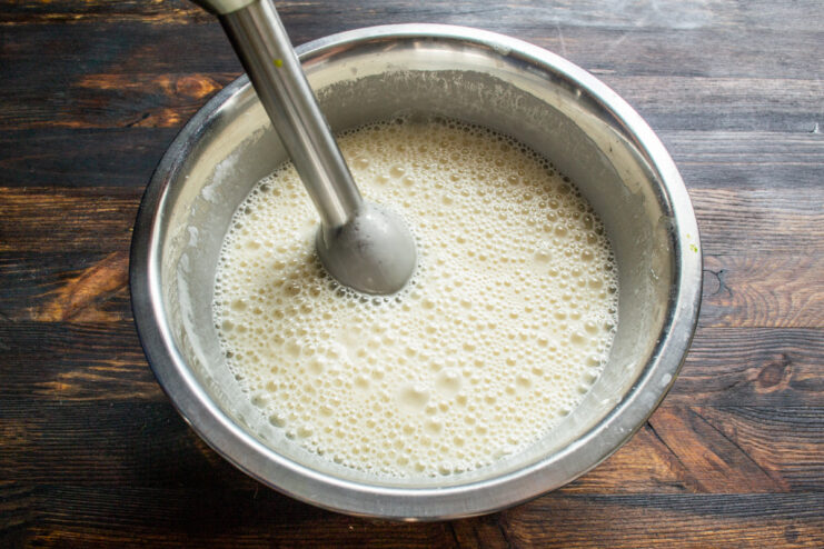 Whisking the batter Whisking crepe batter with a hand blender in a mixing bowl