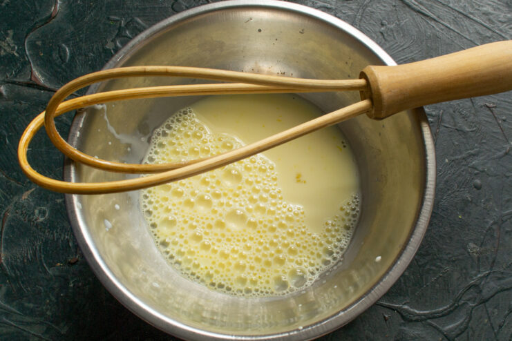 Whisking mixture with sugar and vanilla Whisking cream mixture with sugar and vanilla extract until smooth