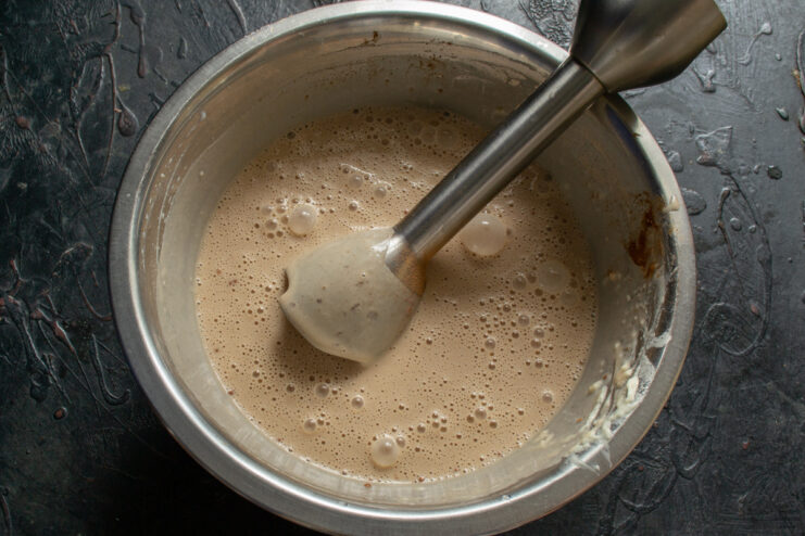 Blending the chocolate crepe batter Using an immersion blender to make a smooth chocolate batter