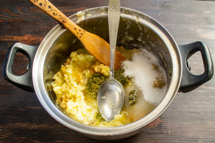 Mixing the Base Ingredients Ground apple puree mixed with sugar and minced green chili in a heavy pot