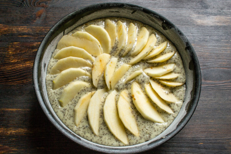 Arranging apple slices in a fan Apple slices beautifully arranged in a fan shape over the batter