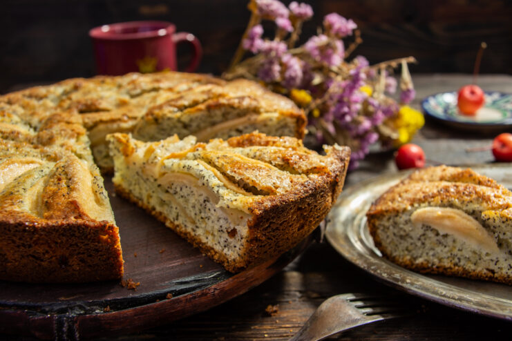 Sliced freshly baked apple cake with crunchy poppy seeds