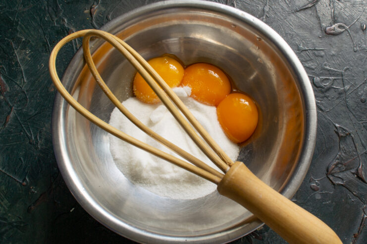 Yolks for the custard Whisking egg yolks and sugar in a metal bowl