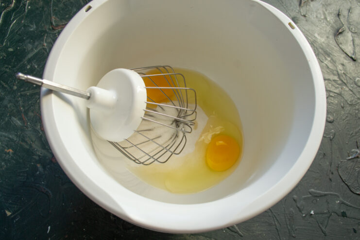 Cookie dough base Eggs and granulated sugar in a mixing bowl before beating