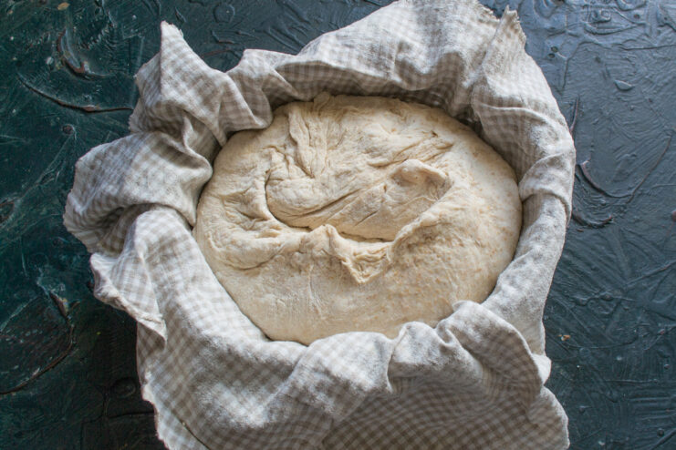 Dough In The Proofing Basket Shaped bread dough placed seam-side up in a proofing basket.