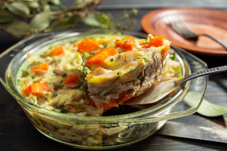 Serving a slice of chicken drumstick aspic on a spatula