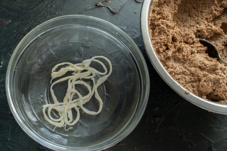 Preparing The Casings Natural pork casings soaking in cold water inside a glass bowl