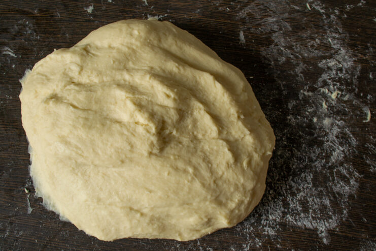 Kneading hot water dough by hand on a floured work surface